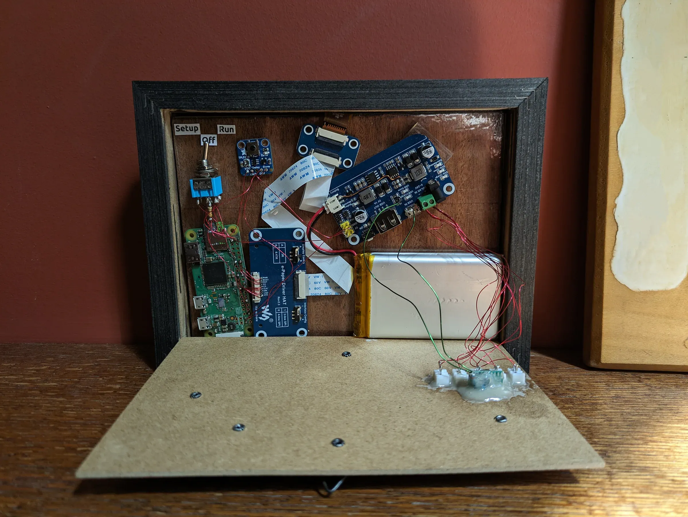 Internal electronics of the Tide Tracker enclosure, including the Raspberry Pi Zero and battery